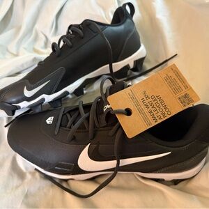 Eco-conscious NIKE cleats with a modern black and white design.